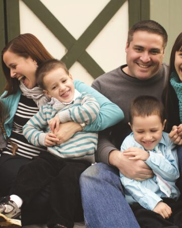 Family tickling each other and giggling