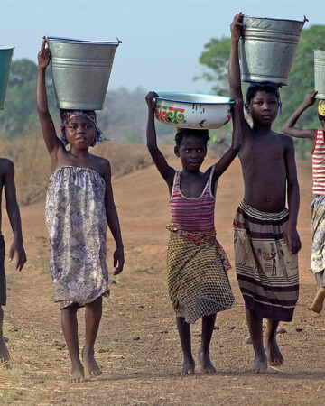 Africans carrying water on their heads